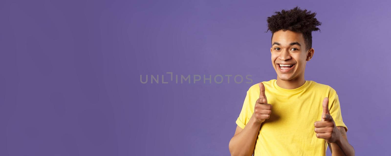 Believe in you. Portrait of cheerful young optimistic guy encuraging to keep going, pointing fingers at camera with happy upbeat smile, picking someone, praising or complimanting.
