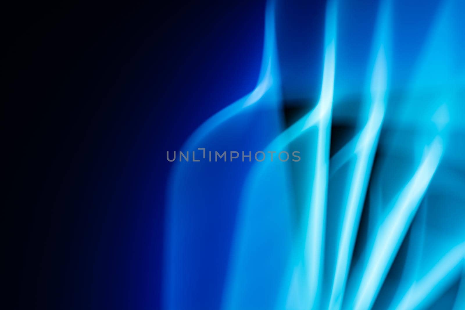 Light from a led lamp in motion in the dark. Technology theme. Abstract banner in blue colors. Back.