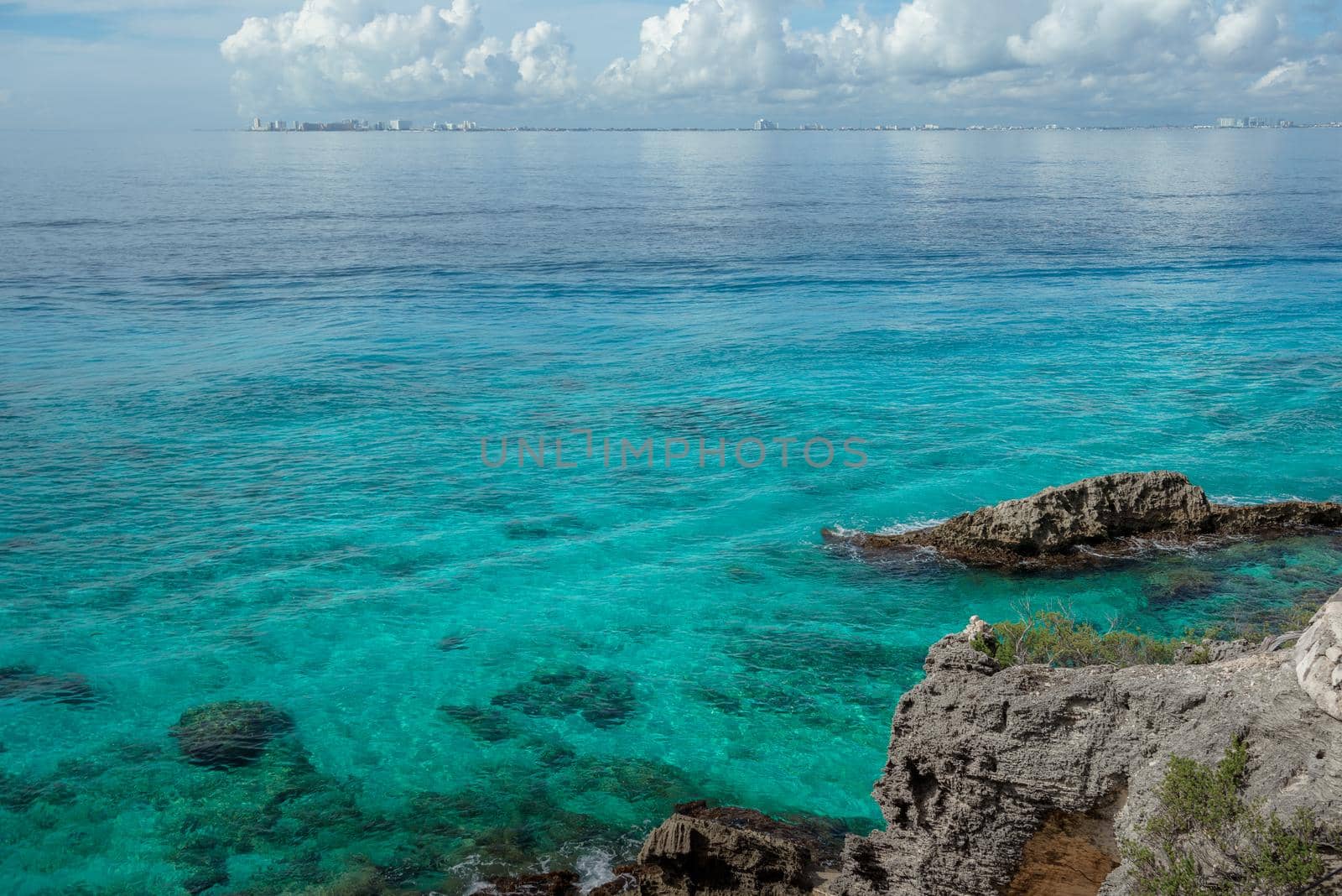 Rocky Caribbean Sea coastline with rocks and azure water on the Isle of Women