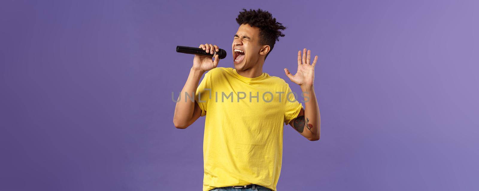 Portrait of passionate carefree young hispanic singer with dreads and tattoos, reaching highest note in song, raising hand up singing loud at microphone with closed eyes, purple background by Benzoix