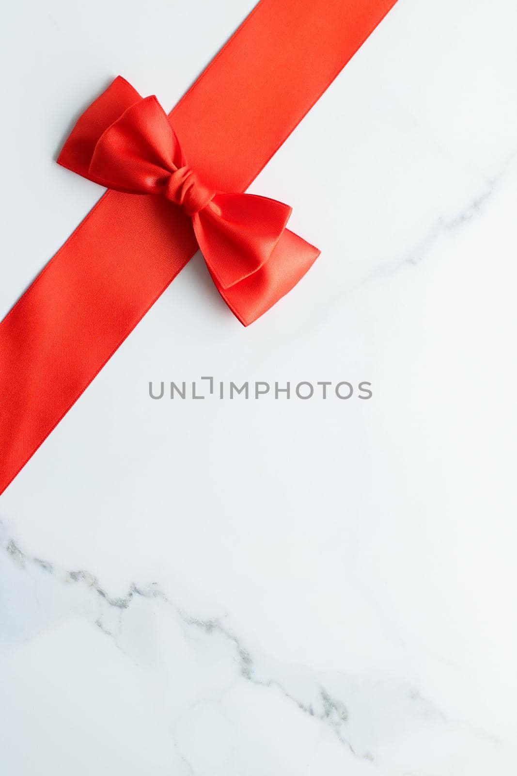 Holiday decor, feminine design and flatlay concept - Red silk ribbon on marble, top view