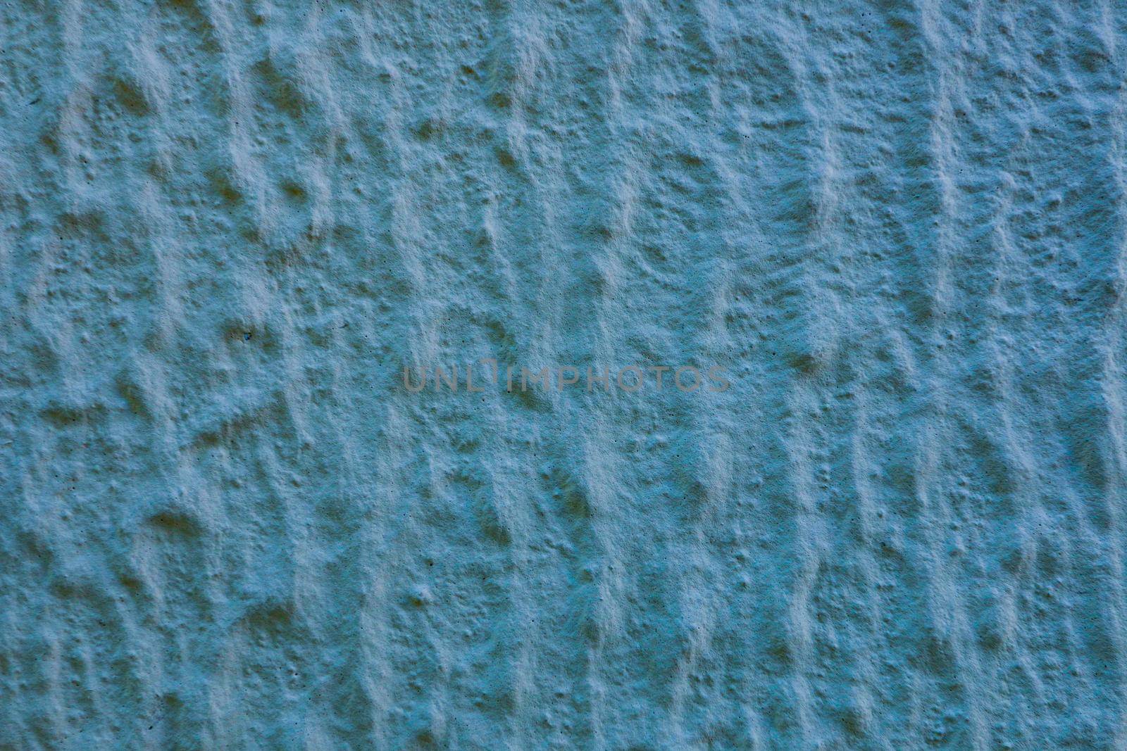 Surface of blue rough embossed decorative plaster on wall. by gelog67