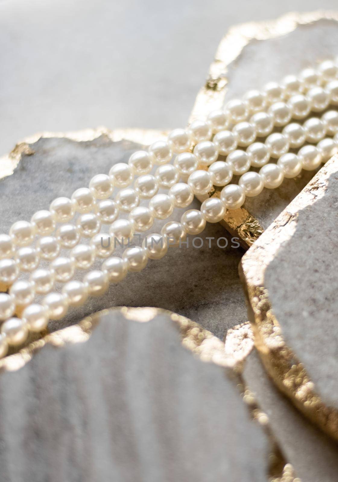 Pearl necklace on golden marble, ethical jewellery - luxury background, jewelry as a gift concept. Pearls are girl's best friends