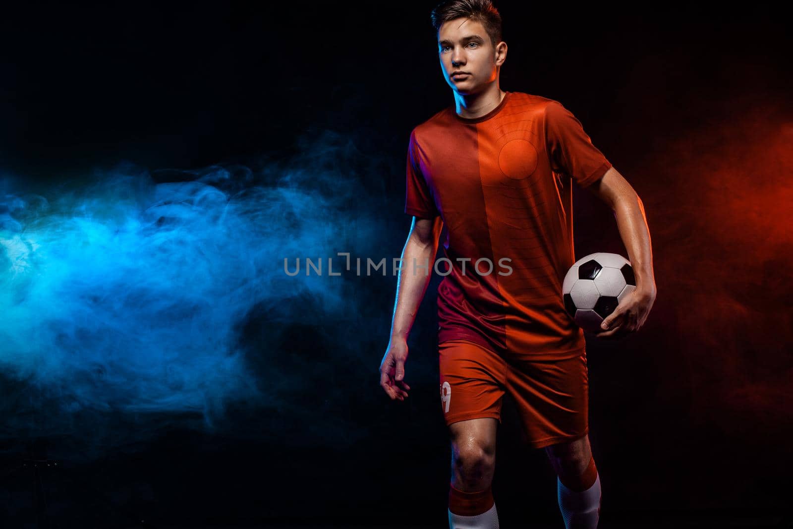 Teenager - soccer player. Boy in football sportswear after game with ball. Sport concept. by MikeOrlov