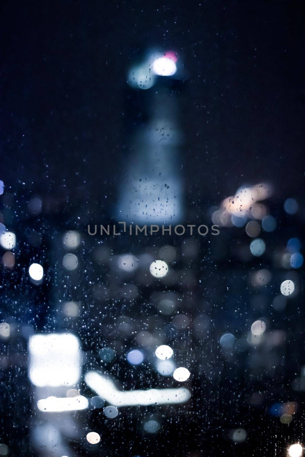 Blurry metropolitan district - night life, abstract background and modern dark tones concept. Big city comes alive at night