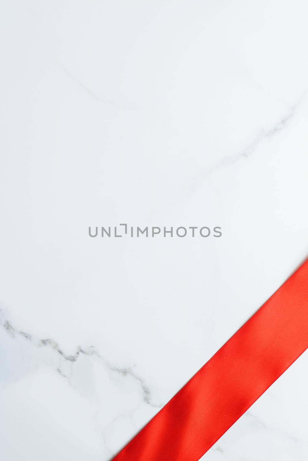 Holiday decor, feminine design and flatlay concept - Red silk ribbon on marble, top view