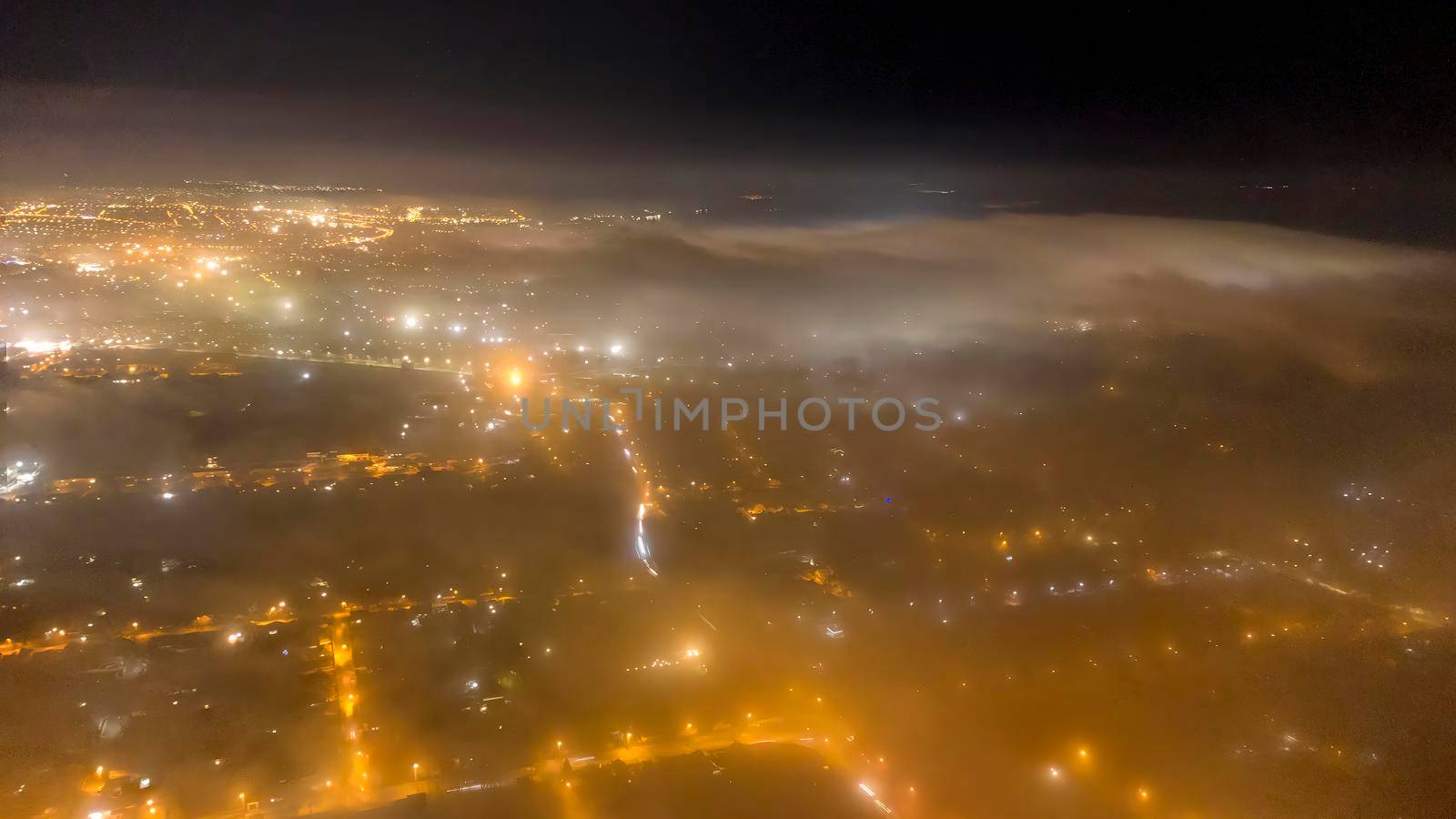 Center city covered in fog during the night. Moody atmosphere. download photo