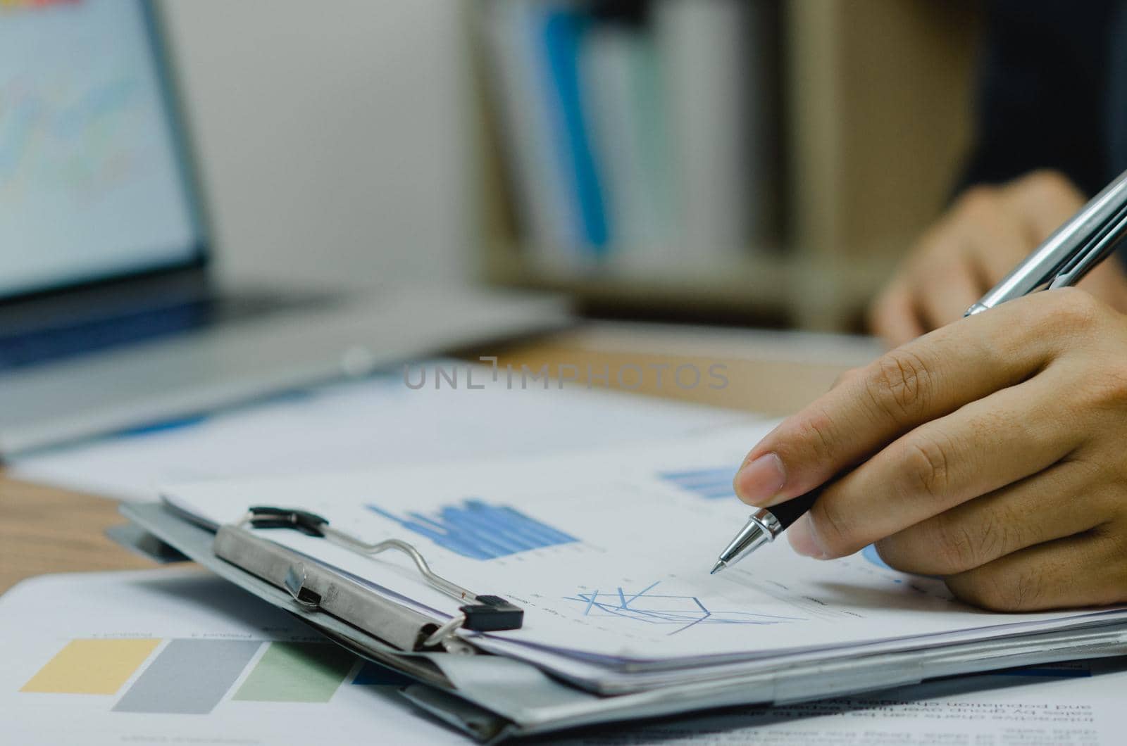 Document graph finance investment growth analysis and chart report information marketing diagram. Man holding pen pointing paperwork.