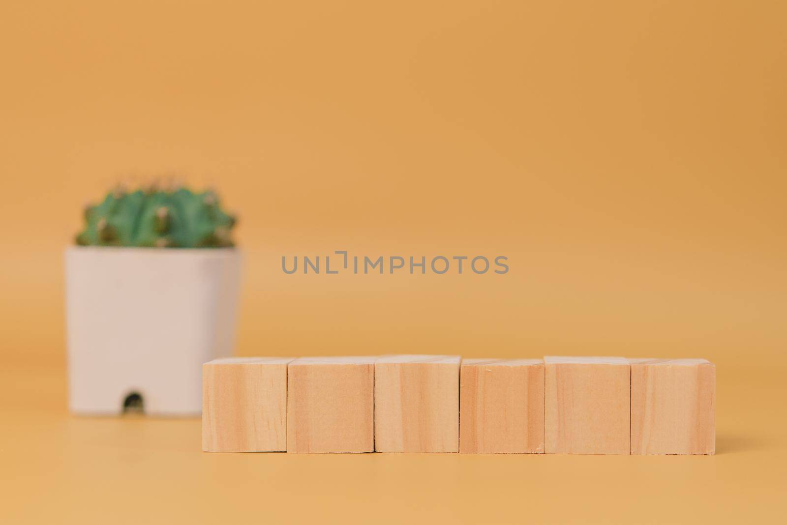 wood cube block blank and tree on yellow background.