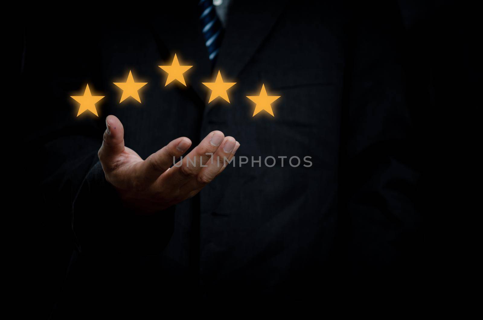 Business man hand customer or client holding the stars to complete five stars with copy space.business satisfaction feedback marketing concept. by aoo3771