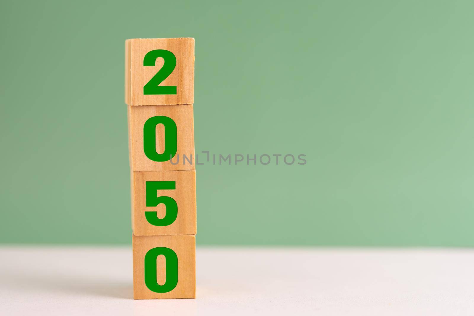 wood cube block net zero target 2050 environmental strategy economy and carbon credit on table background concept. by aoo3771
