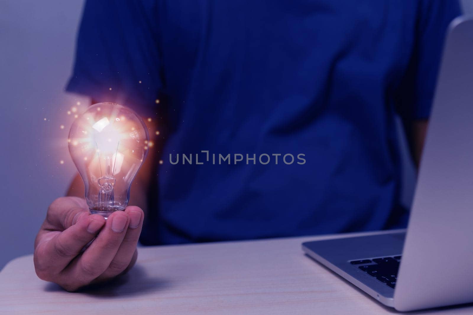 hand hold light bulb and computer on desk.Business innovation Inspiration and Creativity solution success technology Concepts. by aoo3771