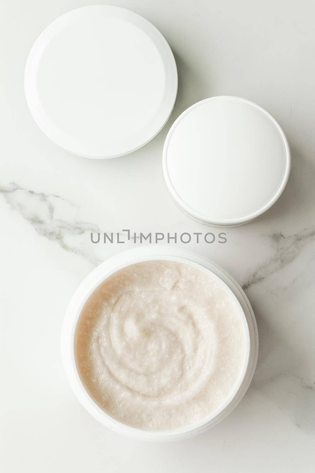 Scrub and exfoliating cream products on a marble, flatlay - skincare and body care, luxury spa and clean cosmetic concept. Health and beauty of your skin