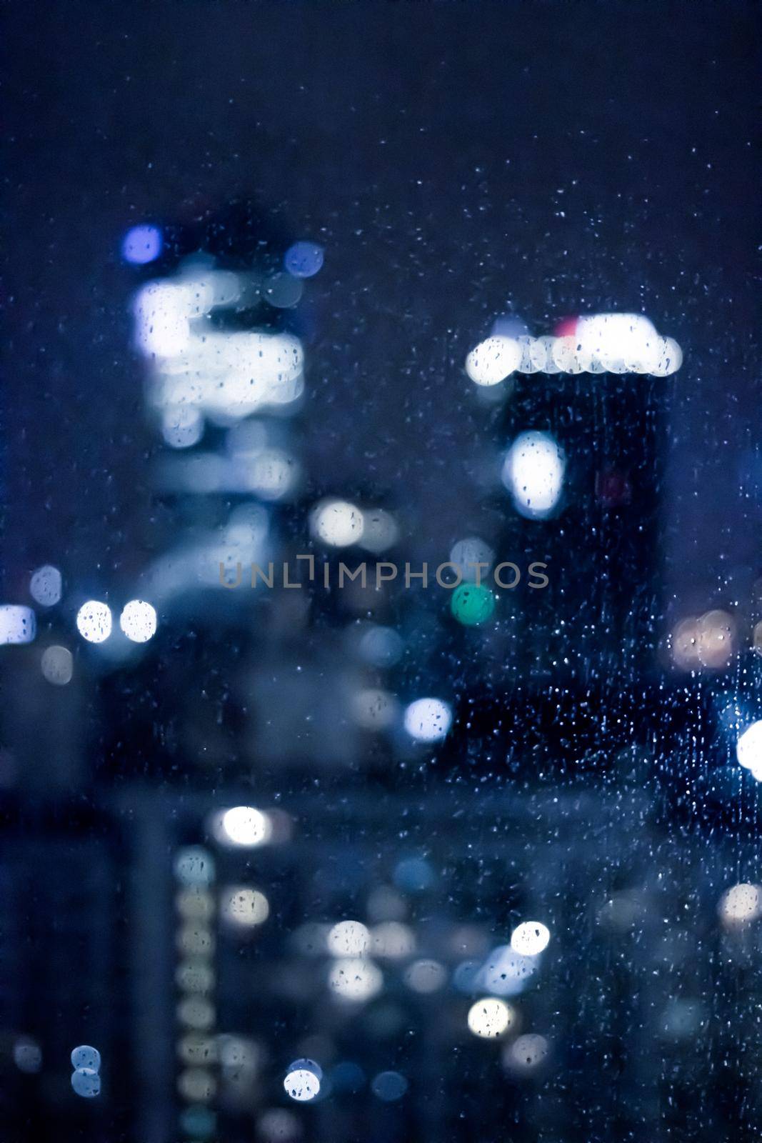 Blurry metropolitan district - night life, abstract background and modern dark tones concept. Big city comes alive at night