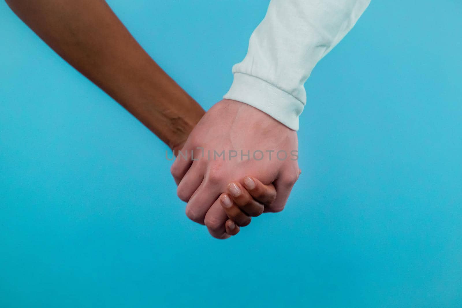 Hands of mixed race woman and white man. Interracial friendship, anti-racism, fraternity. Agreement, cooperation concept by kristina_kokhanova