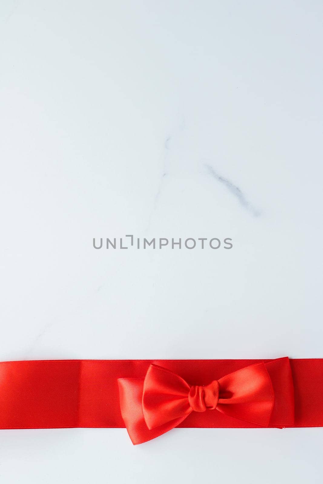 Holiday decor, feminine design and flatlay concept - Red silk ribbon on marble, top view