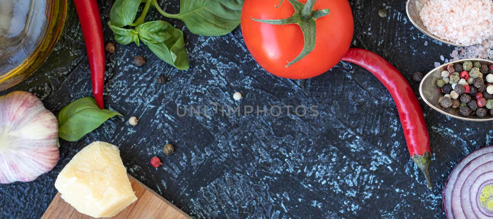 banner with Italian cheese parmesan with tomato, chili and basil. black background with vegetables, herbs, cheese, mix pepper, pink salt, garlic and olive oil with copy space. flat lay top view