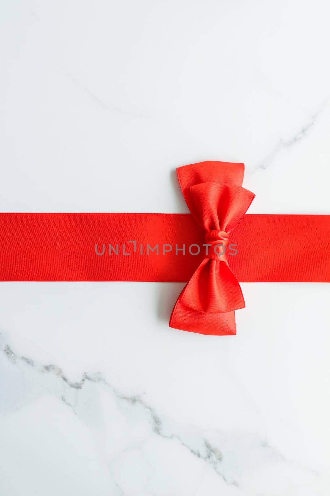 Holiday decor, feminine design and flatlay concept - Red silk ribbon on marble, top view