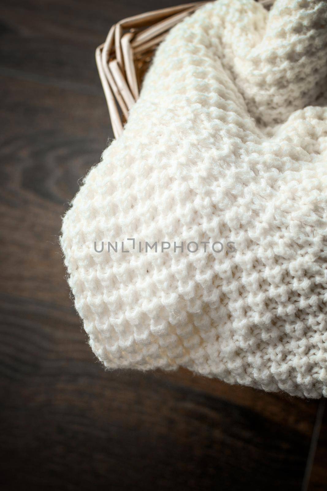 Knitwear, fabric textures and rustic lifestyle concept - Knitted winter clothes in a basket