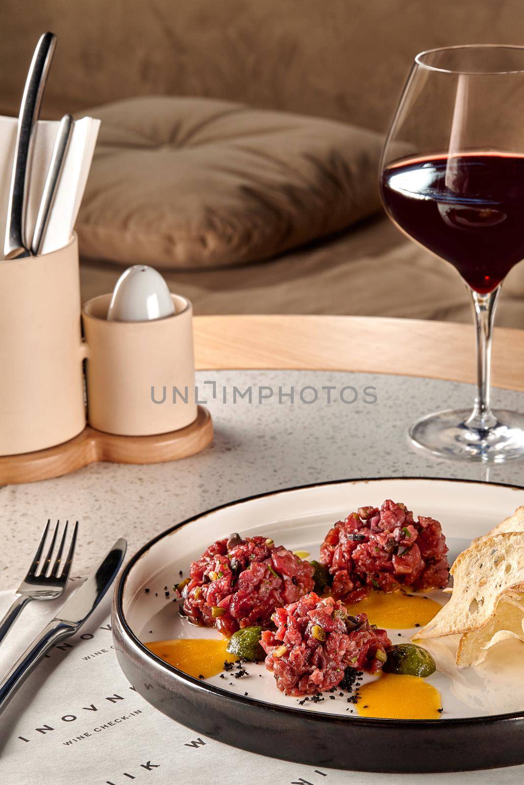 Chips bread with tartare vs carpaccio of beef on table at the restaurant. modern cuisine. Photo for the menu