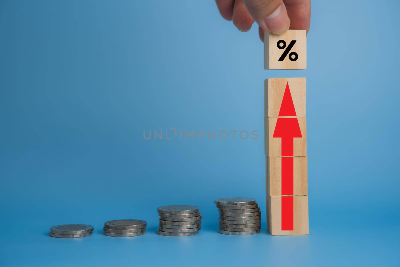 Business finance investments economy stack coin inflation and arrow red with wood cube on desk.