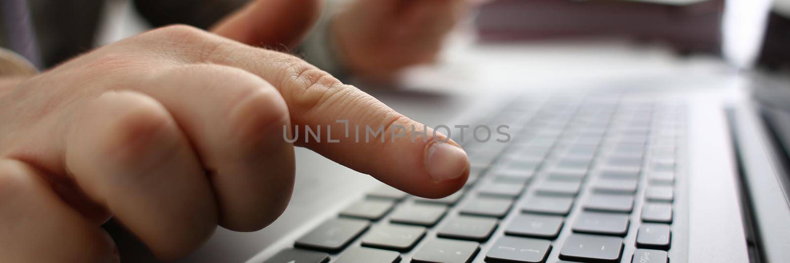 Male hands are holding credit card and typing on keyboard. Financial security and online payments concept