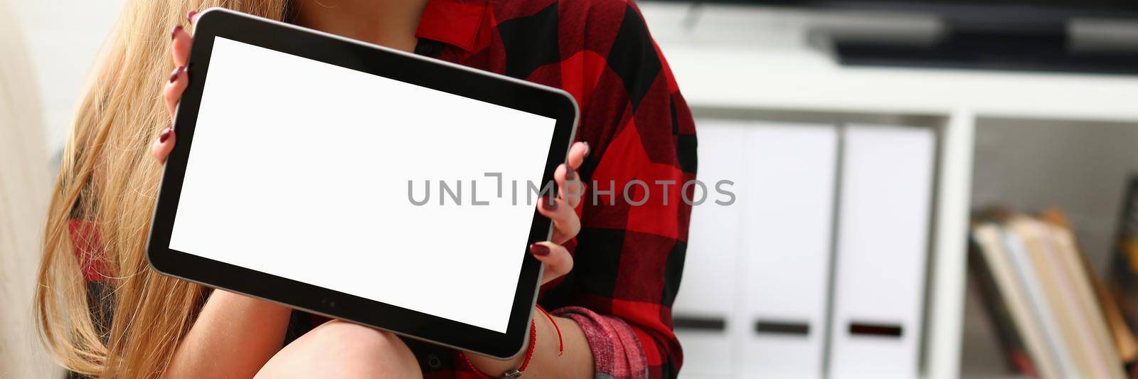 Young beautiful woman holding tablet closeup. Online business app by kuprevich