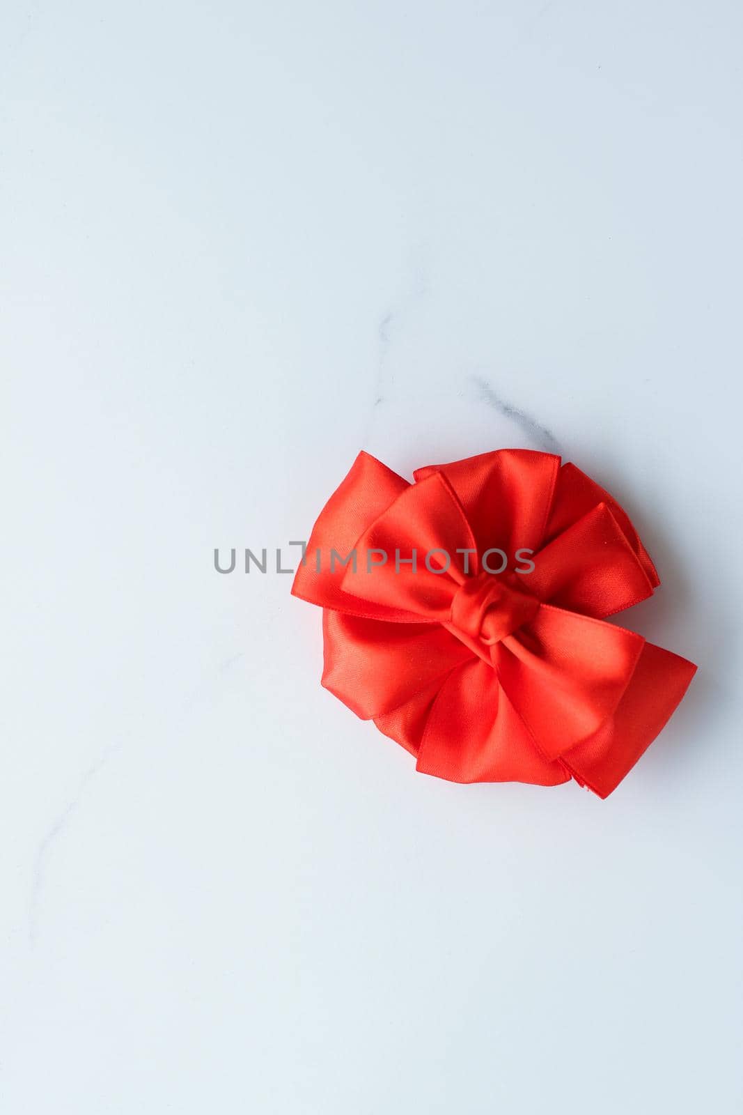 Red silk ribbon on marble, top view by Anneleven