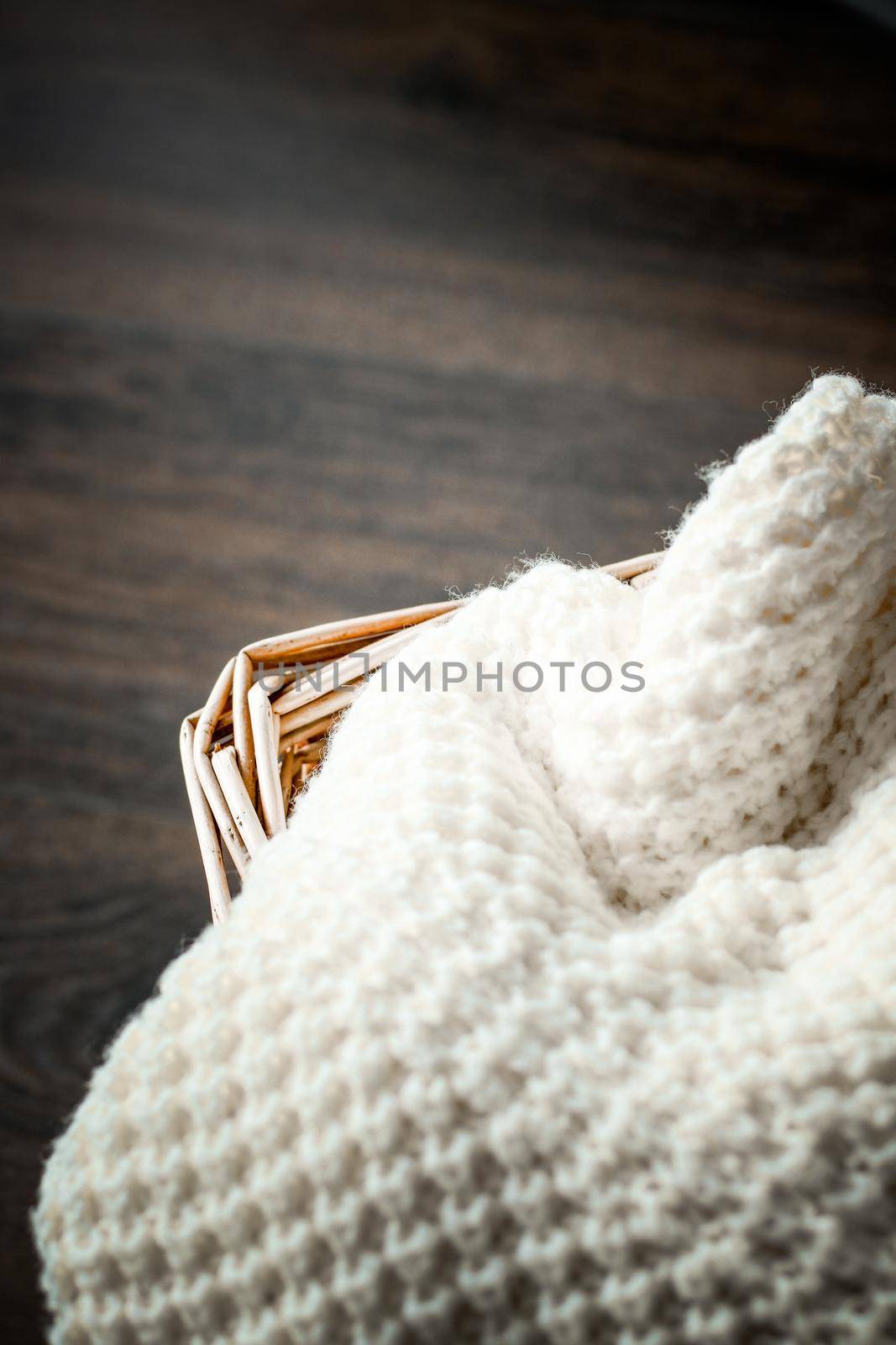 Knitwear, fabric textures and rustic lifestyle concept - Knitted winter clothes in a basket