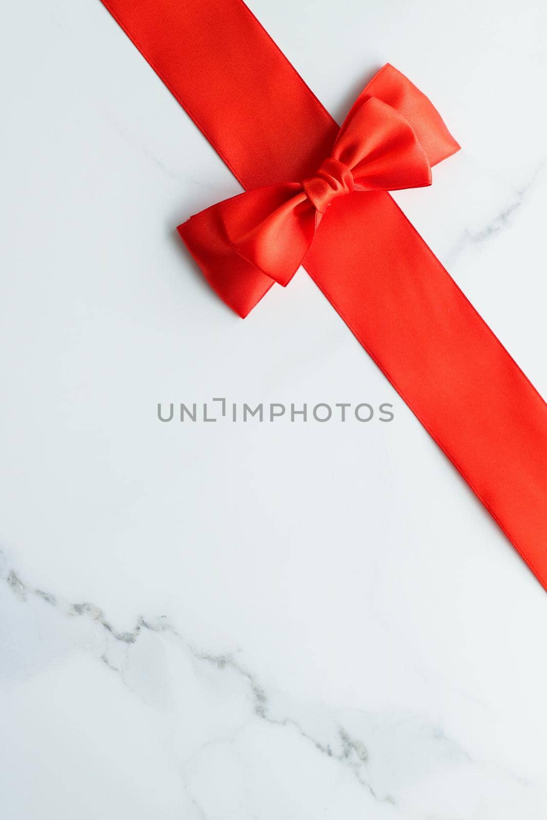 Holiday decor, feminine design and flatlay concept - Red silk ribbon on marble, top view