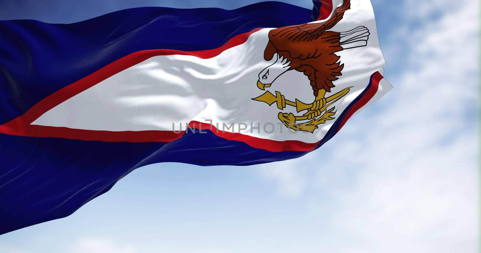 The American Samoa flag in the wind on a clear day. American Samoa is an unincorporated territory of the United States located in the South Pacific Ocean