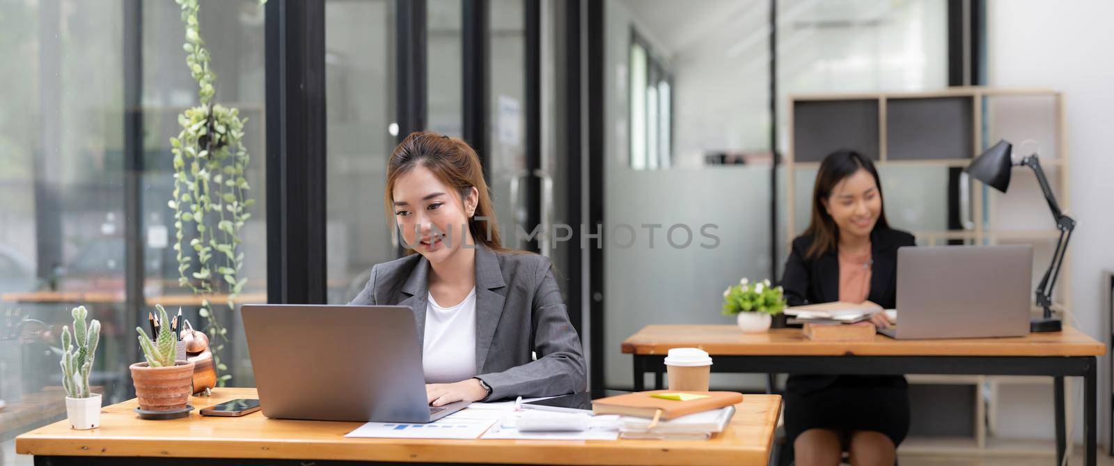 Business asian woman working with laptop computer at office. by nateemee
