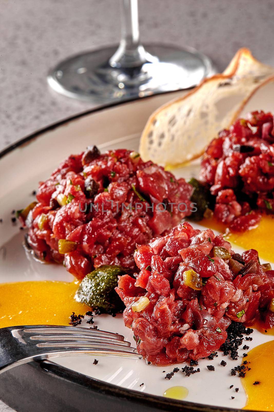 Chips bread with tartare vs carpaccio of beef on table at the restaurant. modern cuisine. Photo for the menu. Close-up