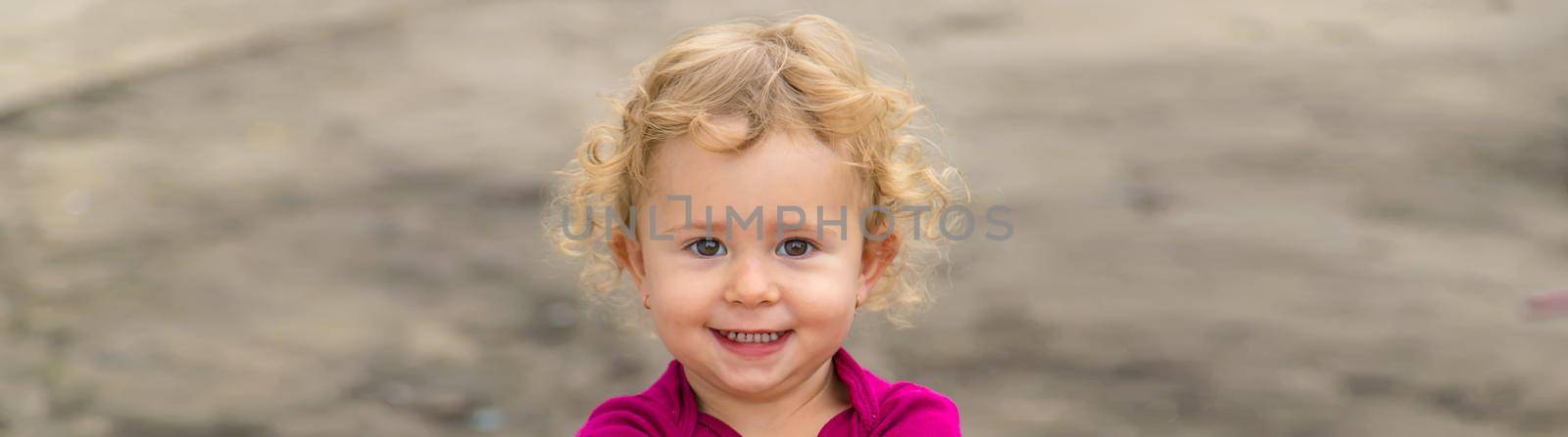 Portrait of a child outdoors girl. Selective focus. by yanadjana