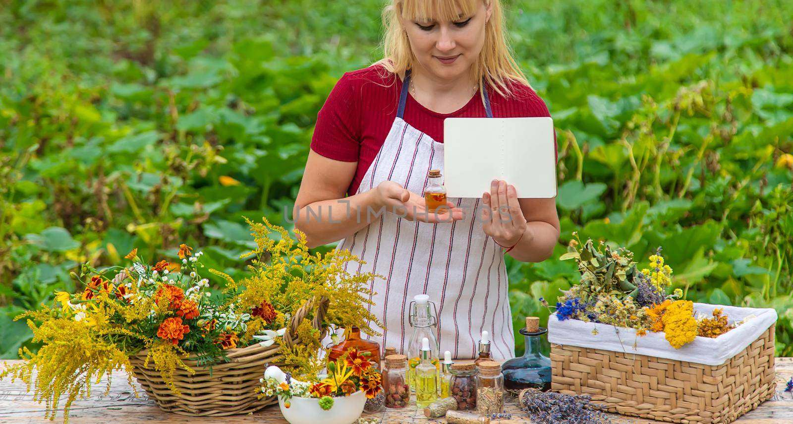 Medicinal herbs on the table. Place for notepad text. woman. Selective focus. nature.