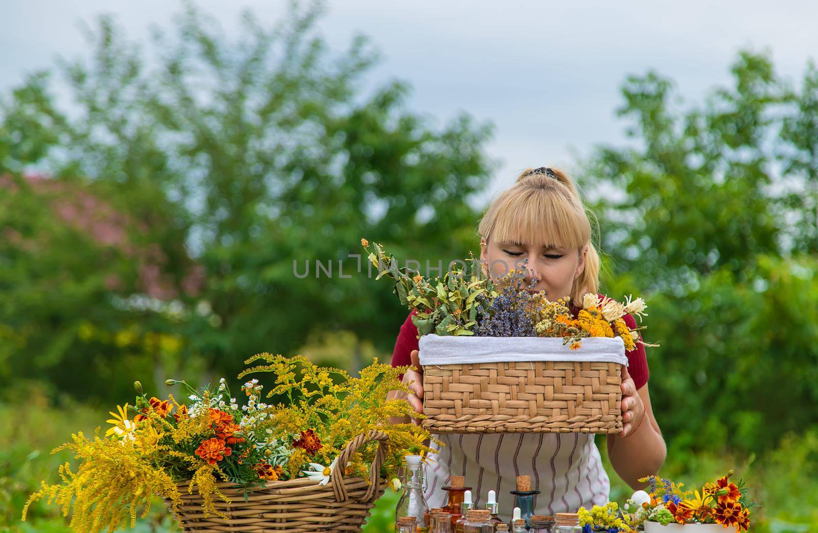 Woman with medicinal herbs and tinctures. Selective focus. Nature.