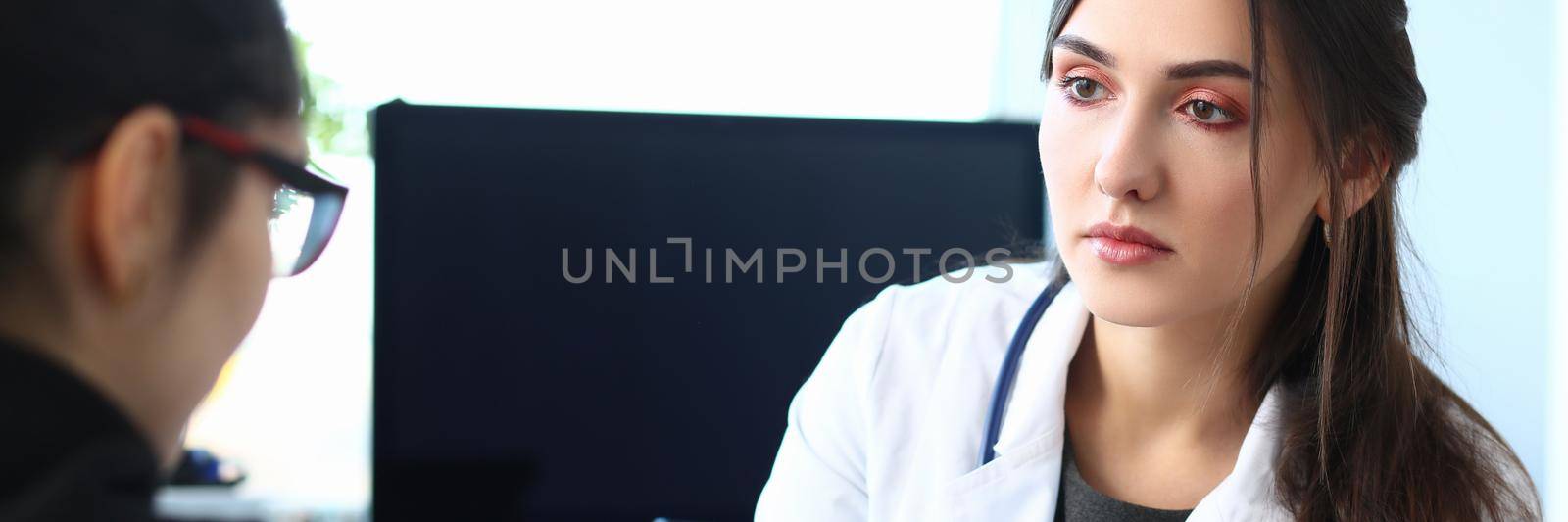 Woman doctor holds patient hand, expressing condolences and sympathy. Bad medical diagnosis concept