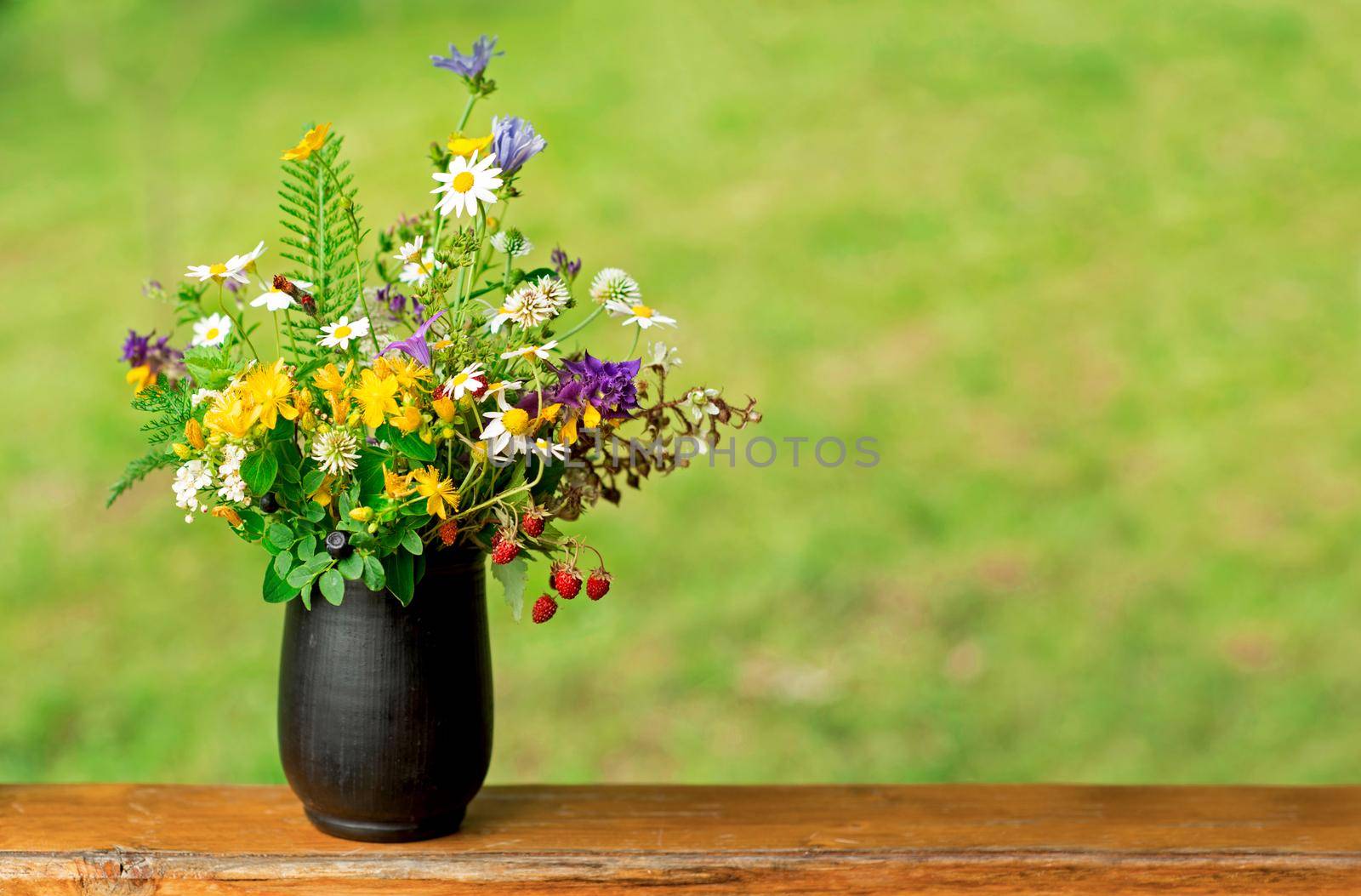 bouquet of wild flowers on a wooden background