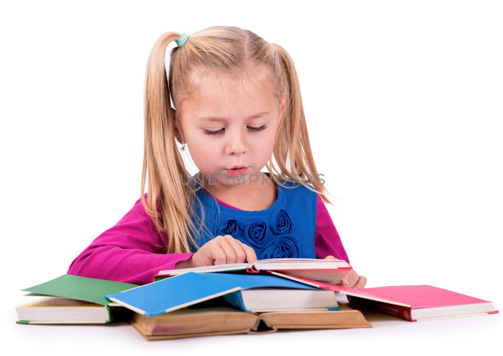 Little smart girl holding a book and reading it, on a white background by aprilphoto