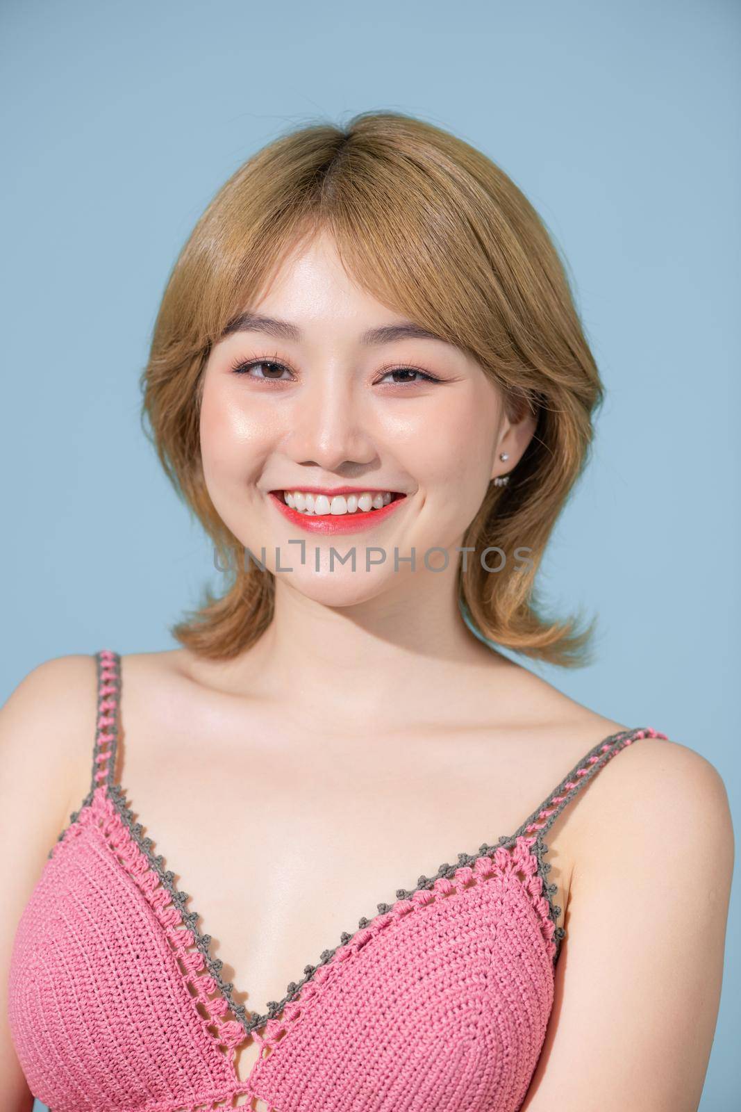 Portrait of young beautiful smiling female in trendy summer clothes. 