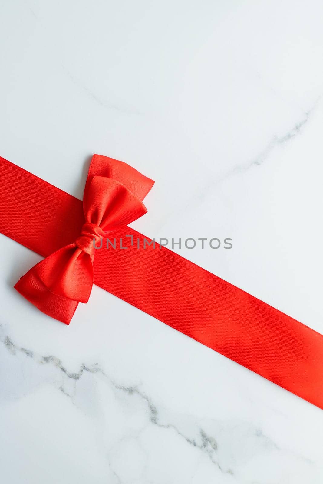 Holiday decor, feminine design and flatlay concept - Red silk ribbon on marble, top view