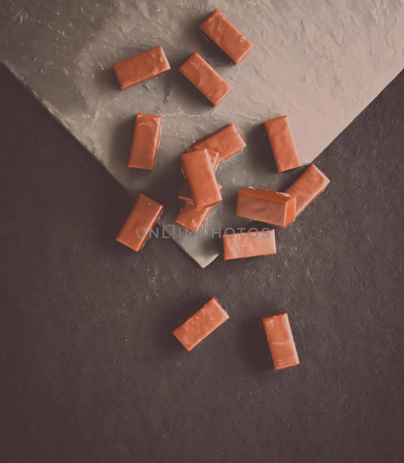 Sweet swiss chocolate candies on a stone tabletop, flatlay - desserts, confectionery and gluten-free organic food concept. All you need is chocolate