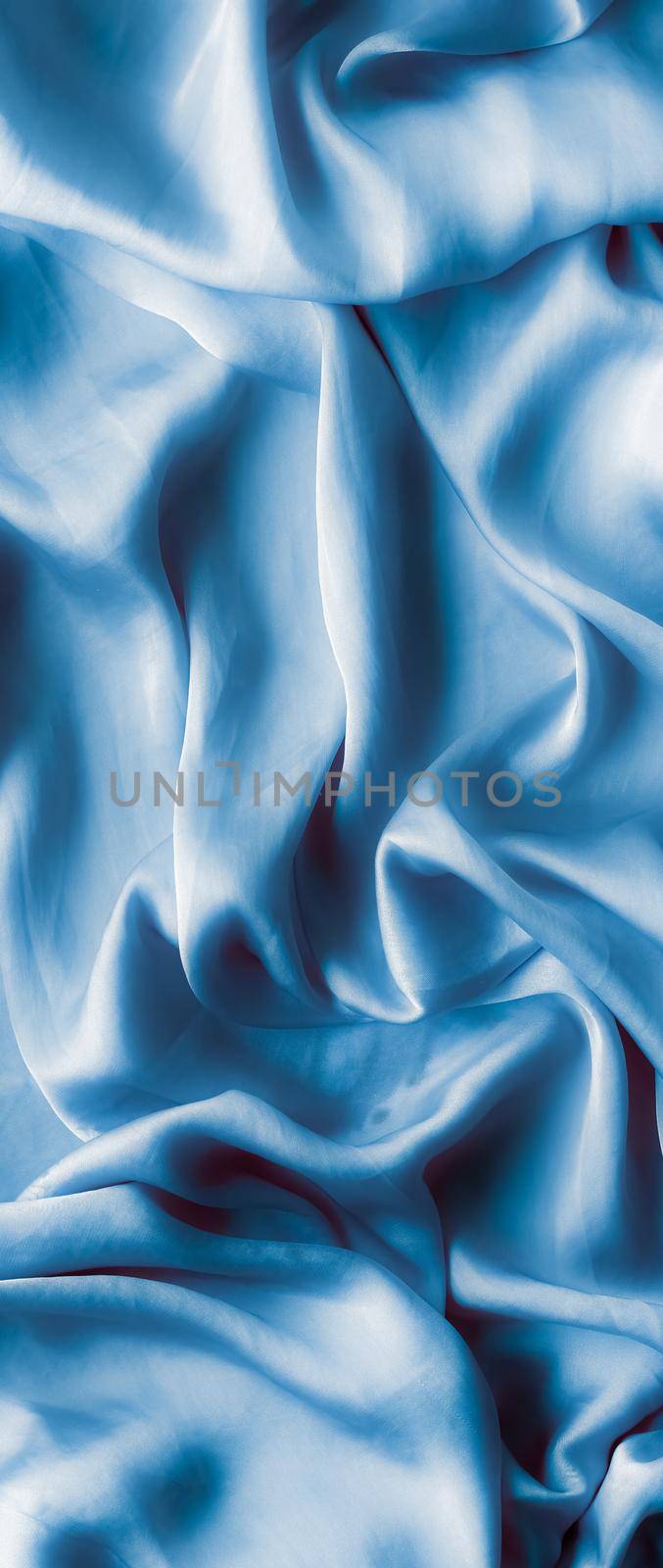 Blue soft silk waves, flatlay - elegant fabric textures, abstract backgrounds and modern pastel colours concept. Feel the touch of luxury