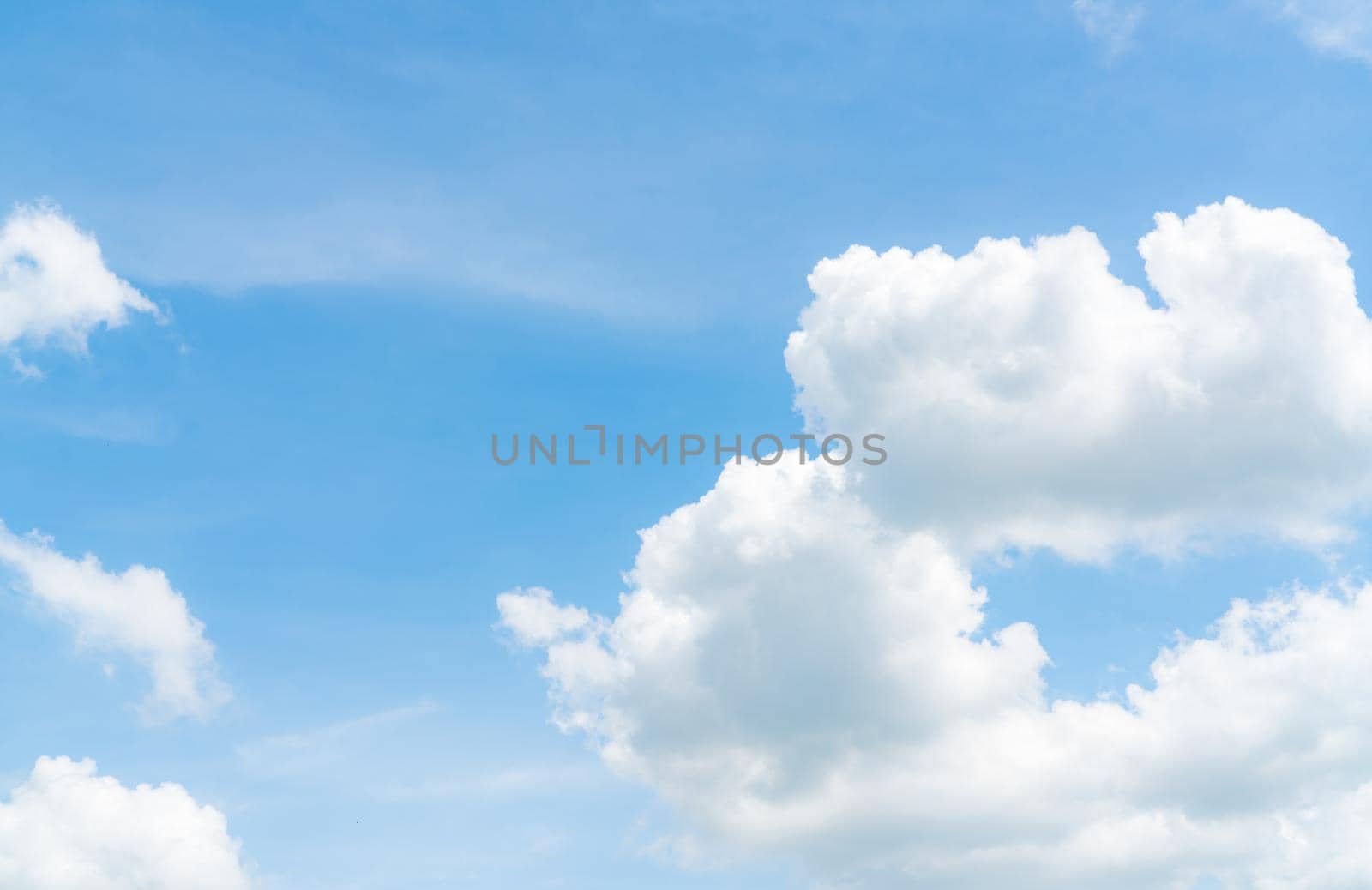Beautiful blue sky and white cumulus clouds abstract background. Cloudscape background. Blue sky and fluffy white clouds on sunny day. Nature weather. Beautiful blue sky for happy day background.  by Fahroni