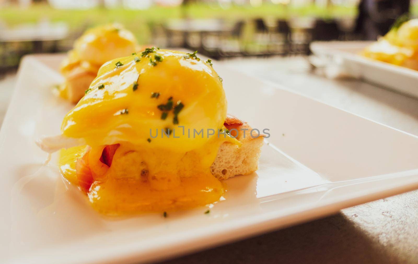 Restaurant service, food recipes and breakfast concept - Poached egg with salmon for brunch in a luxury restaurant