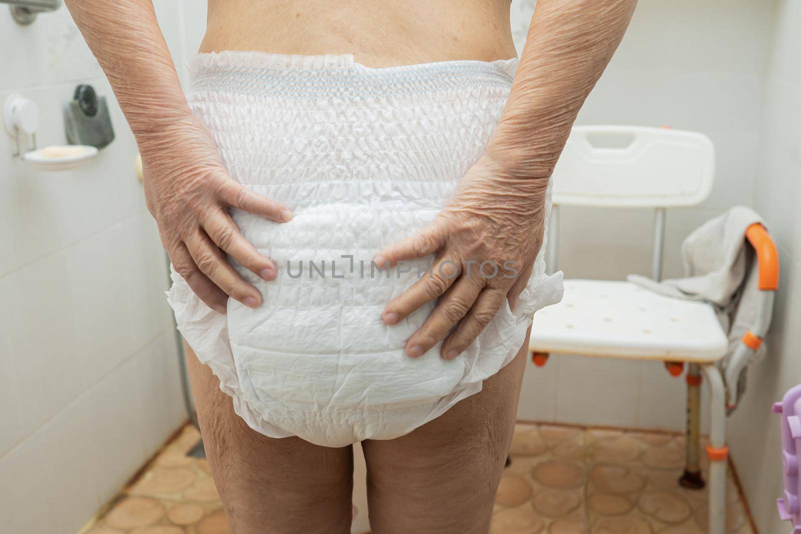 Asian senior or elderly old lady woman patient wearing incontinence diaper in nursing hospital ward, healthy strong medical concept. by pamai