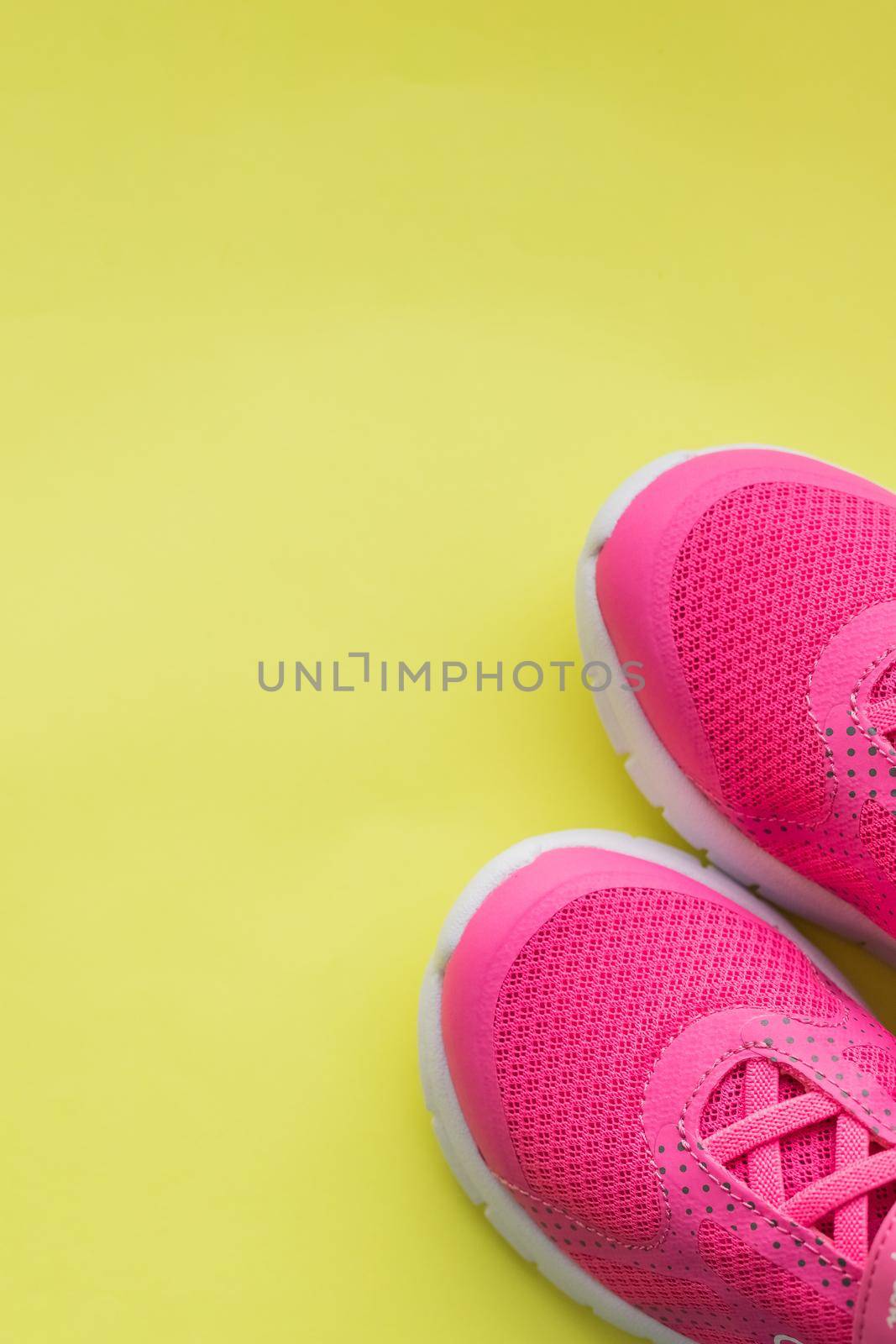 Blue children's sports shoes on a turquoise, mint background. The concept of using sport shoes by children
