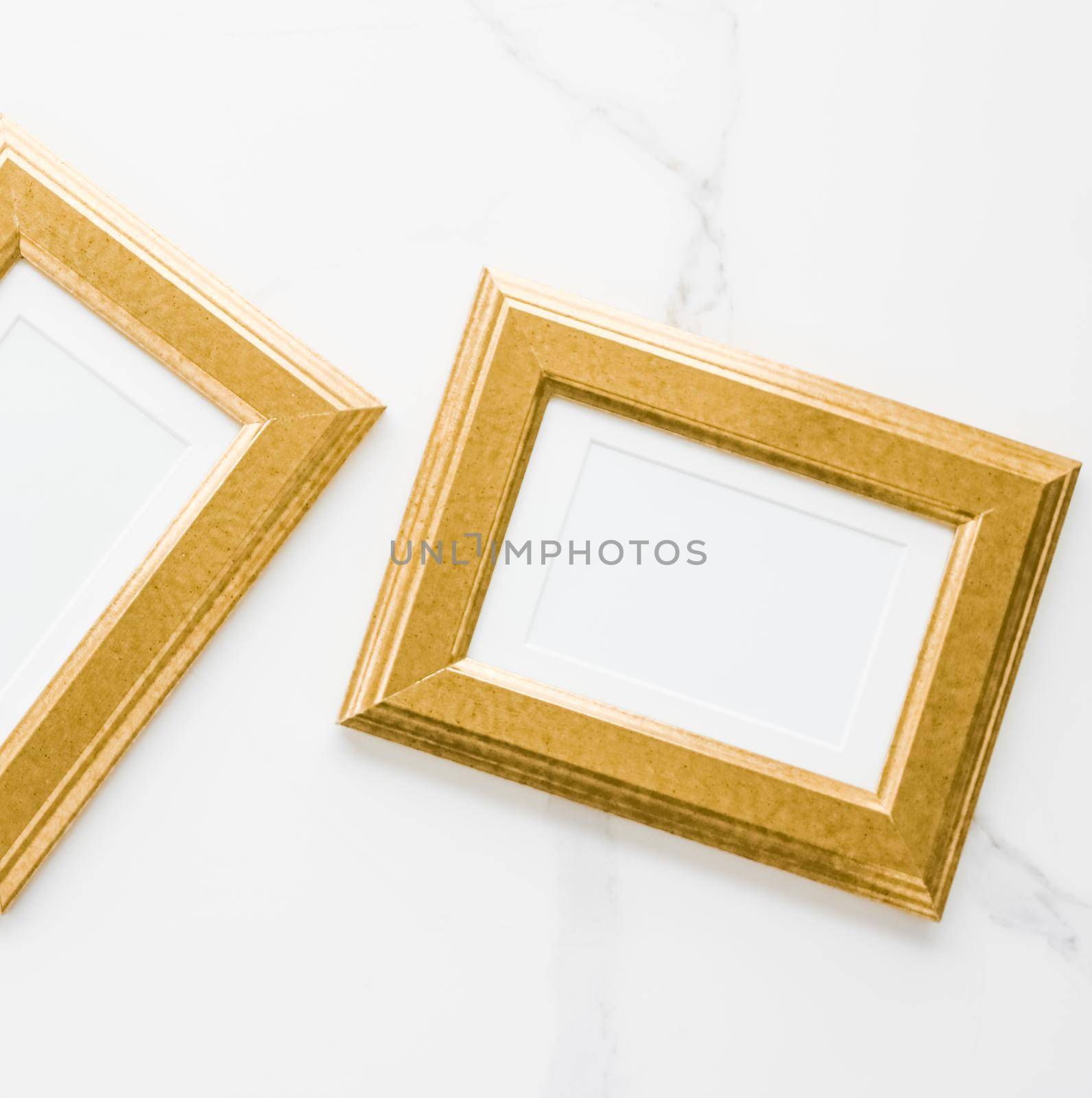 Golden photo frame on marble, flatlay - modern feminine, artwork mock up, luxury design concept. Decorate with chic and style