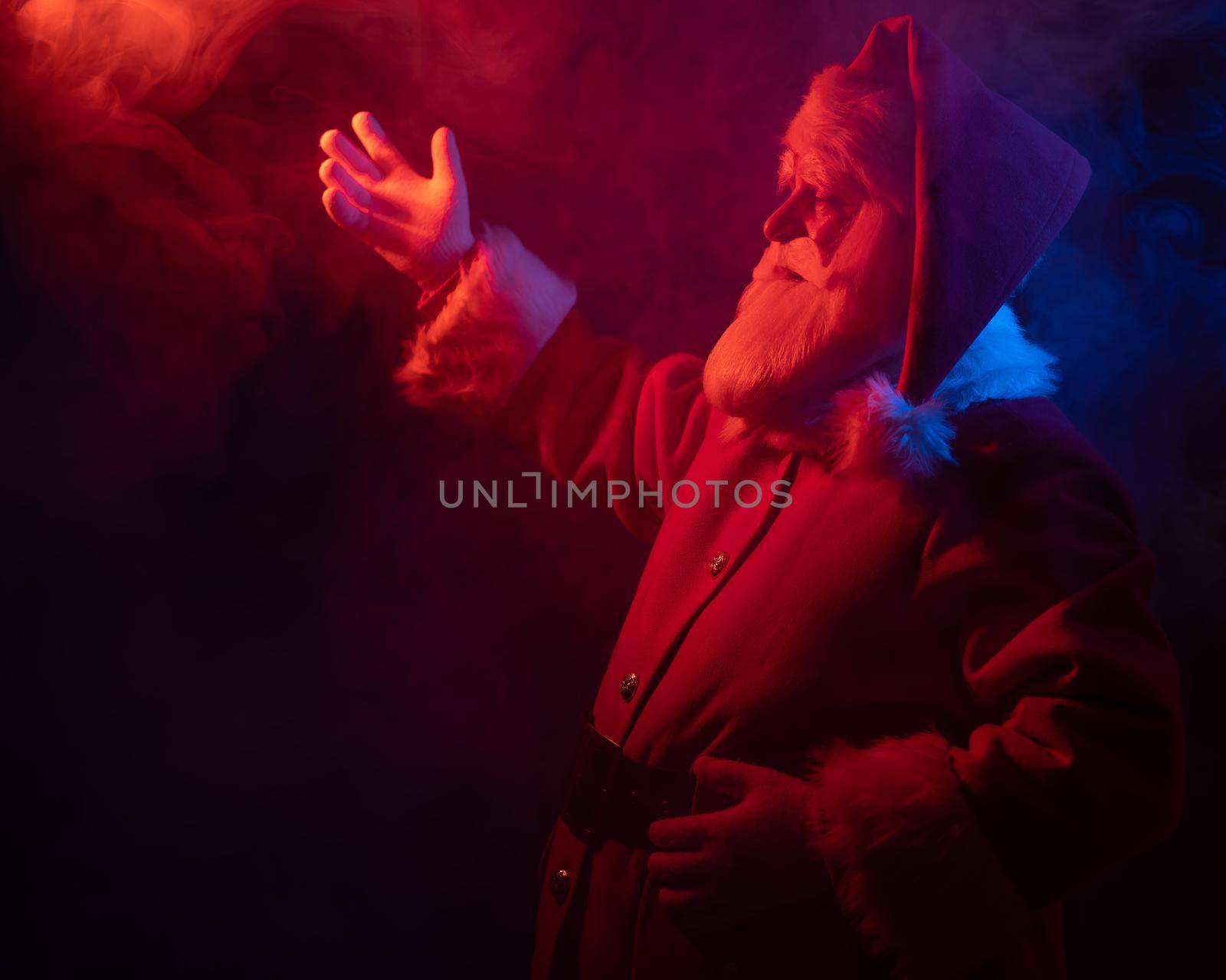 Santa Claus portrait in blue red neon light and smoke