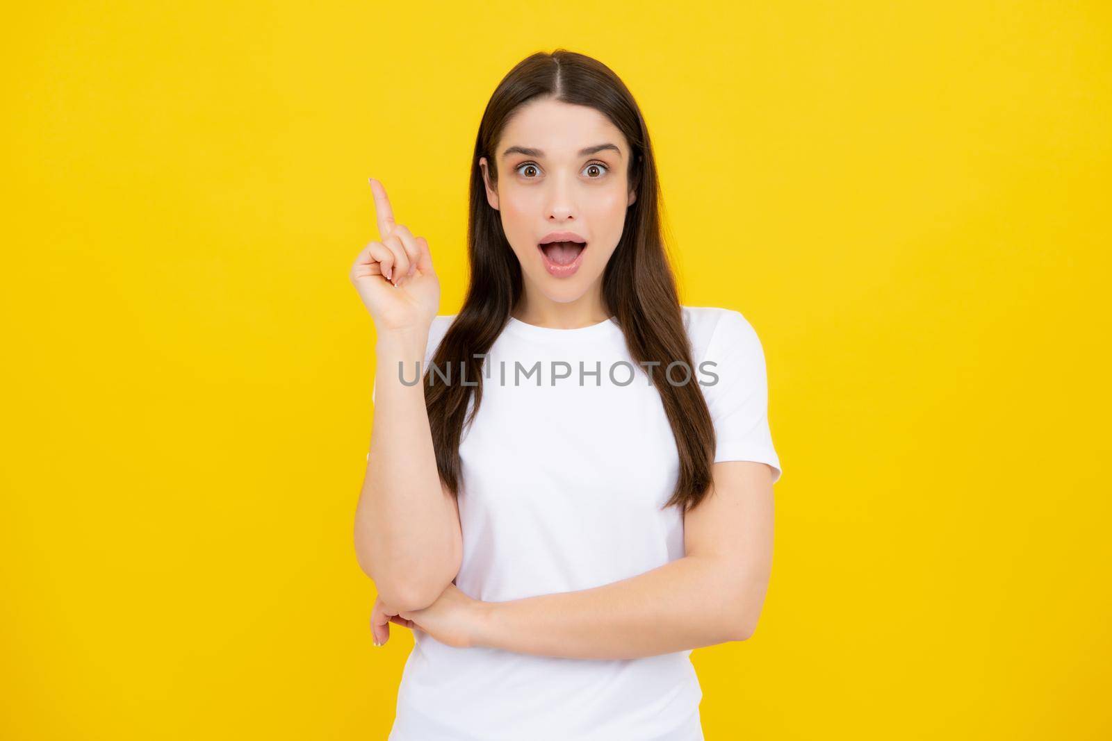 Woman point at copy space, showing copyspace pointing. Promo, girl showing advertisement content gesture, pointing with hand recommend product. Isolated background